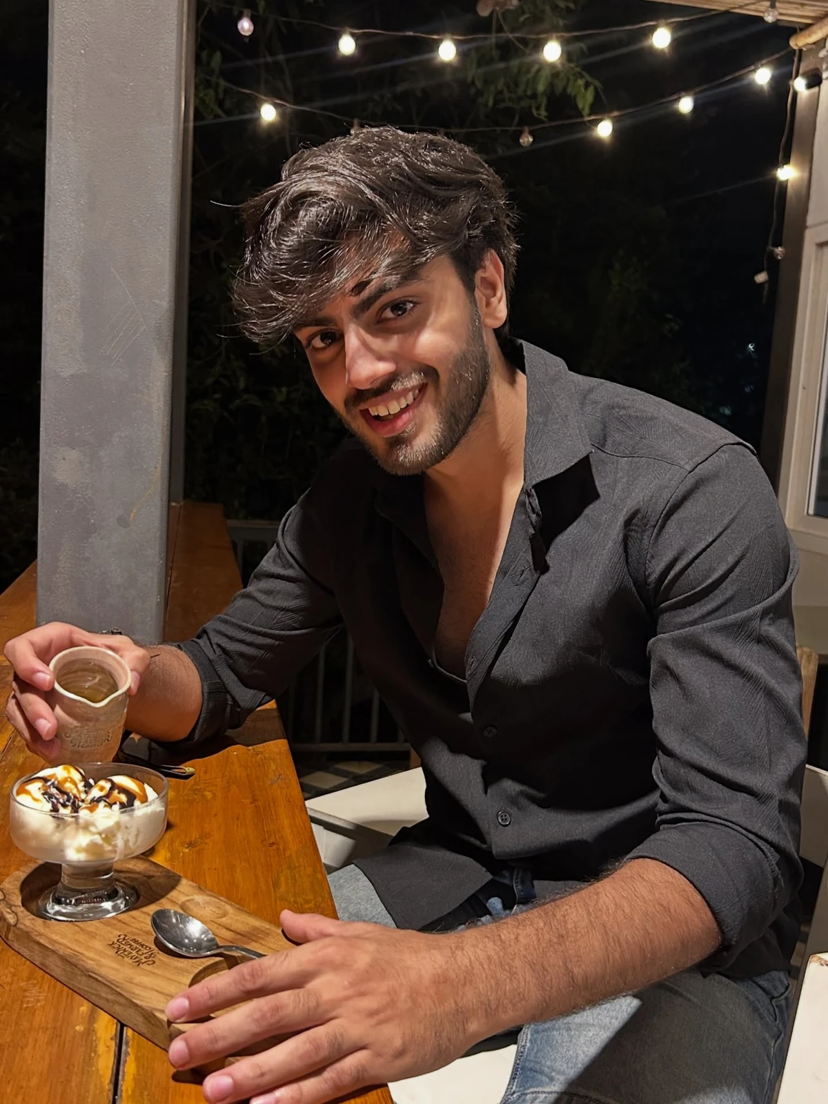 Aditya smiling over coffee